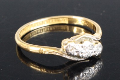 Lot 2554 - An 18ct gold diamond crossover ring featuring...