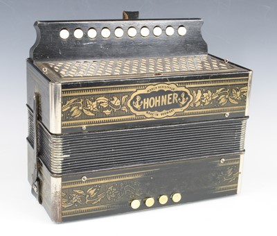 Lot 654 - A Hohner G Melodeon having a poker work type...