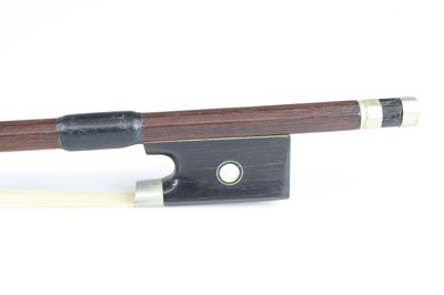 Lot 696 - A violin bow having a nickel adjuster, with...