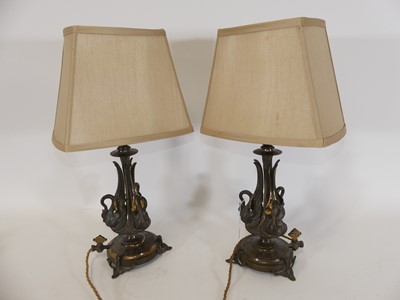 Lot 114 - A pair of brass table lamps, each upon 3 swan...