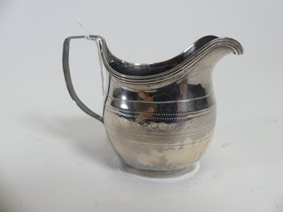 Lot 232 - A George III silver cream jug, of bombe form,...