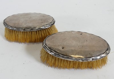 Lot 253 - A pair of silver backed clothes brushes