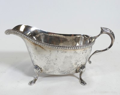 Lot 258 - A George VI silver sauceboat, having cast egg...