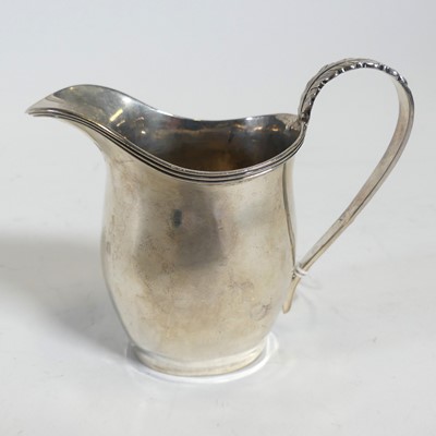 Lot 264 - A George V silver cream jug, having an...