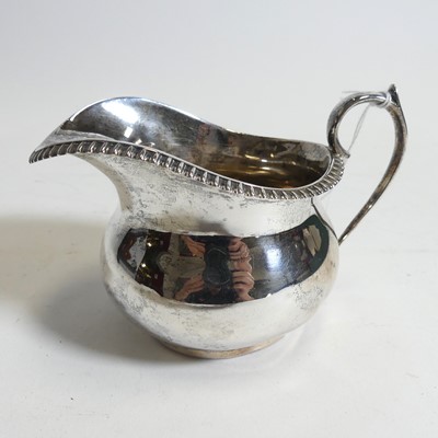 Lot 273 - A George V silver cream jug, of squat bulbous...