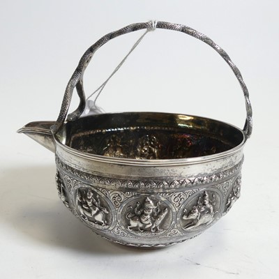 Lot 274 - An Indian white metal jug, having an entwined...