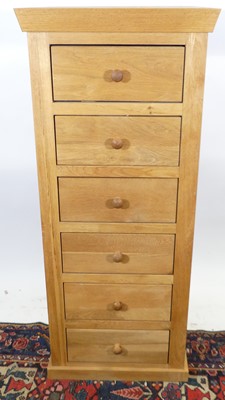 Lot 1239 - A contemporary blond oak narrow chest of six...