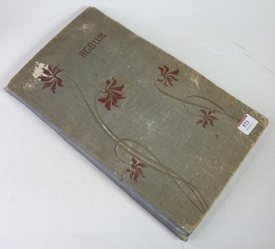 Lot 573 - An early 20th century postcard album...