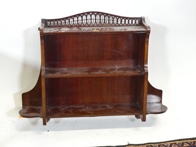 Lot 1274 - An Edwardian mahogany two-tier wall shelf,...