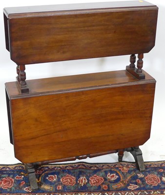 Lot 1281 - An Edwardian walnut two-tier drop flap...