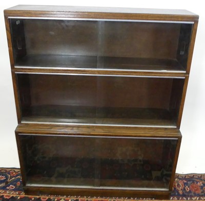 Lot 1283 - A mid-20th century oak three-tier bookcase,...