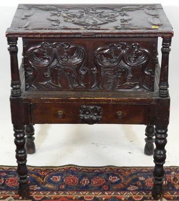 Lot 1244 - An unusual relief carved stained oak hinge top...