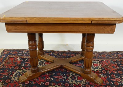 Lot 1295 - A 1930s oak round cornered draw-leaf dining...