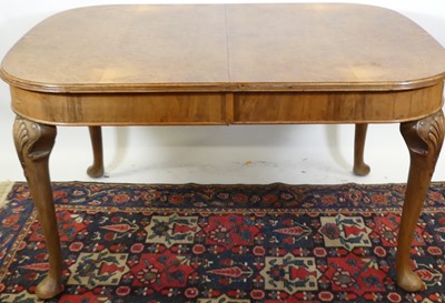 Lot 1312 - A 1920s figured walnut dining suite,...