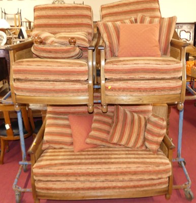 Lot 1336 - A contemporary Ercol mid-elm and cane inset...