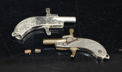 Lot 388 - Two German miniature steel pistols, worn as...