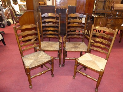 Lot 1370 - A set of four elm and fruitwood ladder back...