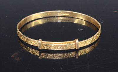 Lot 424 - A modern 9ct gold child's bangle, with...