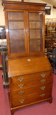 Lot 1402 - A mahogany bureau bookcase, having twin glazed...