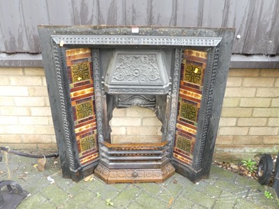 Lot 1431 - An Edwardian cast iron and tile inset fire...