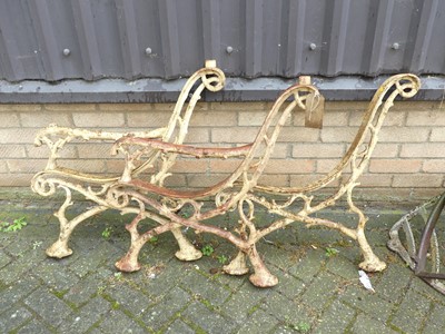 Lot 1438 - A set of three cast iron bench ends in the...