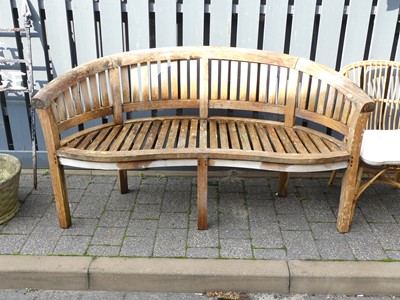 Lot 1441 - A contemporary slatted teak three-seater...