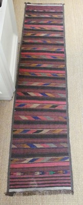 Lot 1262 - A Persian woollen Kelim hall runner, with...