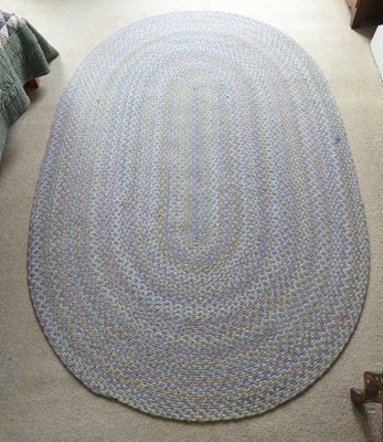 Lot 1256 - A contemporary braided oval rug, as radiating...