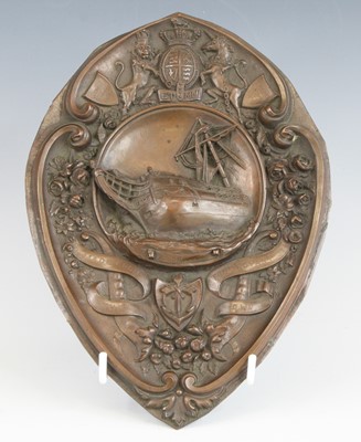 Lot 524 - A copper plaque of oval form, the central...