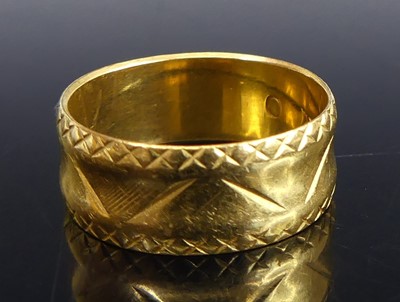 Lot 2666 - A 22ct gold 7/5mm engraved concave wedding...