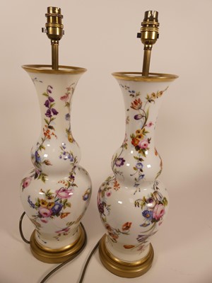 Lot 5 - A pair of floral decorated porcelain table...