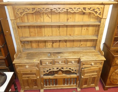 Lot 1144 - A rustic pine kitchen dresser, with two-tier...