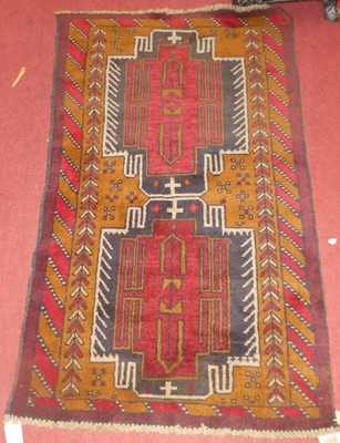 Lot 1163 - A Persian woollen deep rust ground prayer rug,...