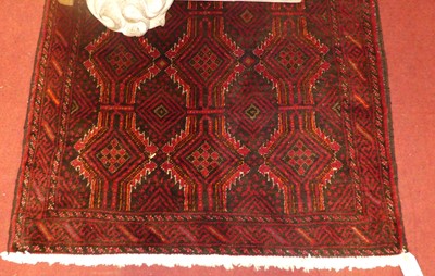 Lot 1164 - A Persian woollen red ground Bokhara rug, 190...