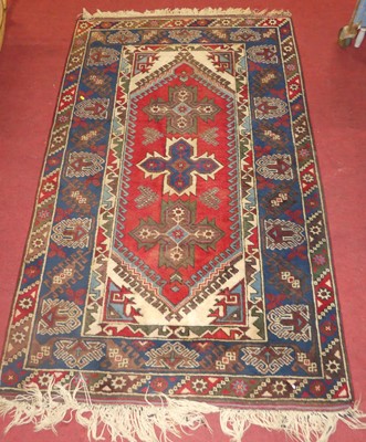 Lot 1166 - A Turkish woollen red and blue ground tribal...