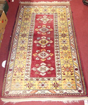 Lot 1168 - A Turkish woollen red ground tribal Kelim rug,...