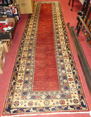 Lot 1169 - A Turkish woollen red ground long hall runner,...