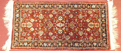 Lot 1173 - A small Chinese silk red ground hall rug, 95 x...