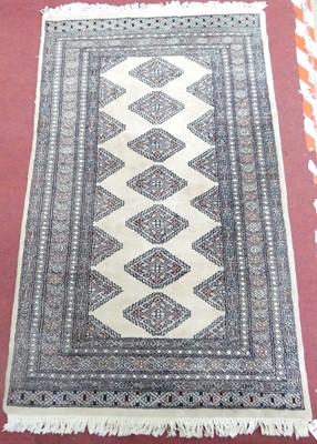 Lot 1175 - A Pakistani pale ground woollen rug, with...