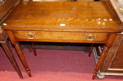 Lot 1251 - A contemporary oak fold over tea table, having...