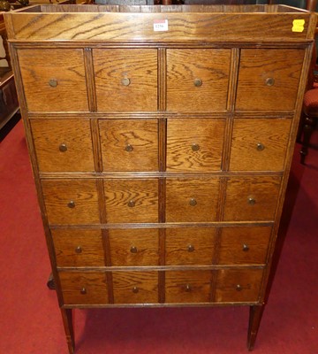 Lot 1256 - A contemporary oak bank of twelve variously...