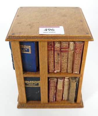 Lot 496 - A miniature oak revolving bookcase, containing...