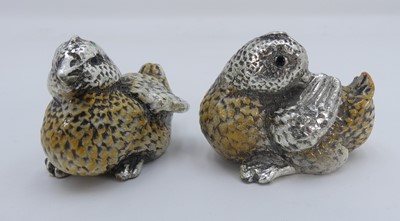 Lot 380 - A pair of enamel decorated white metal models...