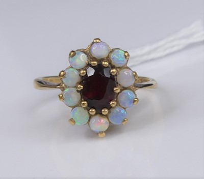 Lot 305 - A 9ct gold, garnet and opal set flower-head...