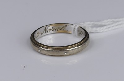 Lot 306 - A 9ct white gold band ring, inscribed to the...