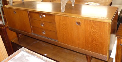 Lot 1362 - A 1960s teak long sideboard, having three...