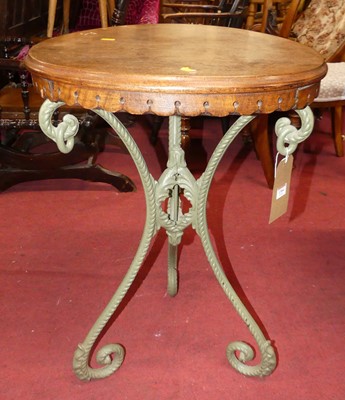 Lot 1364 - A green painted cast iron based and walnut...