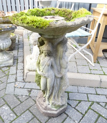 Lot 1413 - A reconstituted stone pedestal birdbath, the...