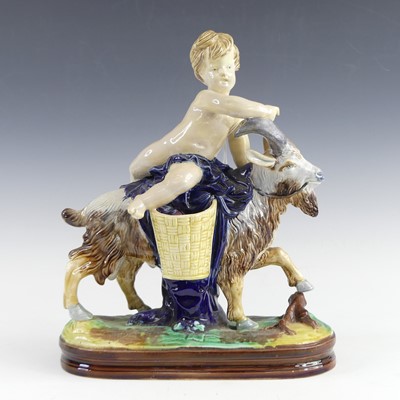 Lot 2122 - A Minton majolica figure of a child riding a...