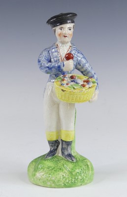 Lot 2121 - A Staffordshire pearlware figure of a boy,...